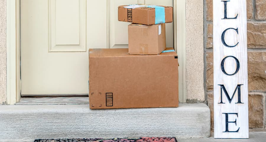 Deliveries on the front porch of a house with a welcome sign in Grand Rapids